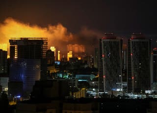 An explosion of a drone lights up the sky over the city during Russian drone and missile strikes in Kyiv